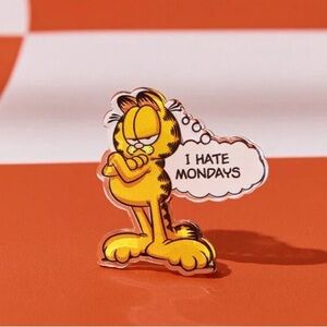 Garfield, cartoon cat, with a thought bubble stating "I HATE MONDAYS” Pin